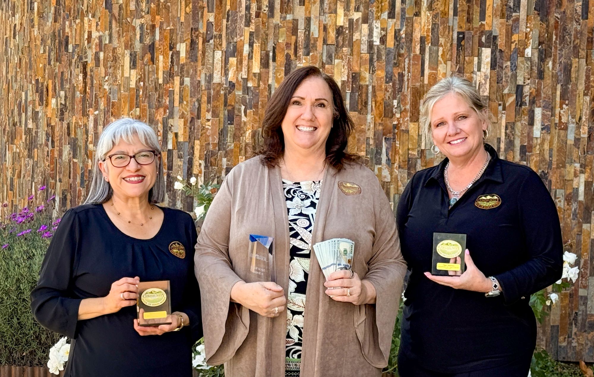 Photo of employees holding various items